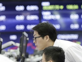 A currency trader watches computer monitors at the foreign exchange dealing room in Seoul, South Korea, Thursday, Sept. 27, 2018. Asian markets were mixed on Thursday after the U.S. Federal Reserve lifted its key interest rate as expected for the third time this year.