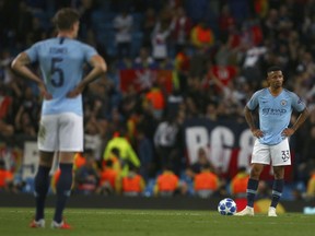 Manchester City's Gabriel Jesus, right, and Manchester City's John Stones, left, stand with their hands on their hips after Lyon score their second goal during the Champions League Group F soccer match between Manchester City and Lyon at the Etihad stadium in Manchester, England, Wednesday, Sept. 19, 2018.