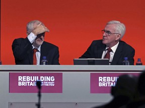 Britian's Labour leader Jeremy Corbyn, left, and Shadow Chancellor of the Exchequer John McDonnell look on during the Labour Party's annual conference at the Arena and Convention Centre (ACC), in Liverpool, England, Monday, Sept. 24, 2018. Britain's main opposition party took a step at its annual conference toward backing a new referendum on Brexit -- but stopped short of saying the vote should include an option not to leave the European Union at all.
