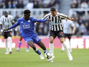 Leicester City's Wilfred Ndidi, left, and Newcastle United's Ayoze Perez battle for the ball during their English Premier League soccer match at St James' Park, Newcastle, England, Saturday, Sept. 29, 2018.