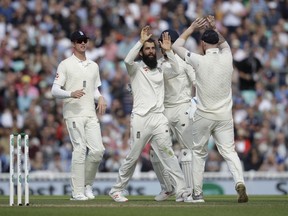 England's Moeen Ali, second left, celebrates taking the wicket of India's Hanuma Vihari during the fifth cricket test match of a five match series between England and India at the Oval cricket ground in London, Sunday, Sept. 9, 2018.