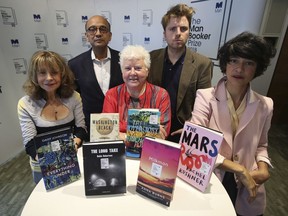 The panel of judges, from left, Jacqueline Rose, Kwame Anthony Appiah, Val McDermid, Leo Robson and Leanne Shapton pose for a photo, during the Man Booker Prize 2018 shortlist announcement, at Riverbank House, in  London, Thursday, Sept. 20, 2018. Three U.K. authors, two Americans and a Canadian are finalists for the Man Booker Prize for fiction. The shortlist announced Thursday includes two first novels: U.K. poet Robin Robertson's verse novel "The Long Take" and "Everything Under" by British writer Daisy Johnson. The American finalists are Rachel Kushner's prison story "The Mars Room" and Richard Powers' tree-inspired tale "The Overstory."