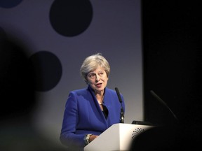 Britain's Prime Minister Theresa May makes a speech at the Zero Emission Vehicle Summit at the ICC in Birmingham, England, Tuesday, Sept. 11, 2018.