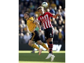 Wolverhampton Wanderers' Diogo Jota, left, and Southampton's Jannik Vestergaard in action during the English Premier League soccer match at Molineux stadium in Wolverhampton, England, Saturday Sept. 29, 2018.