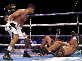 Amir Khan, left, knocks down Samuel Vargas in action during their Welterweight contest at Arena Birmingham, in Birmingham, England, Saturday Sept. 8, 2018.