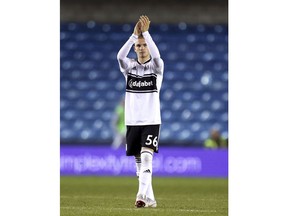 Fulham's Harvey Elliott applauds the fans at full time after the game against Millwall during the third round English League Cup soccer match at The New Den in London, Tuesday Sept. 25, 2018. Elliott has become the youngest-ever player to feature for Fulham at 15-years and 174 days old.