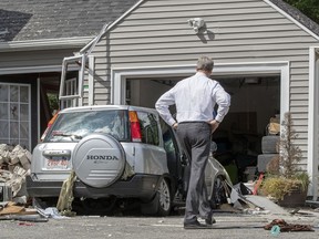 Massachusetts Gov. Charlie Baker tours 35 Chickering St., where a young man was killed during a gas explosion in Lawrence, Mass, Friday, Sept. 14, 2018. Investigators worked Friday to pinpoint the cause of a series of fiery natural gas explosions that killed a teen driver in his car just hours after he got his license.