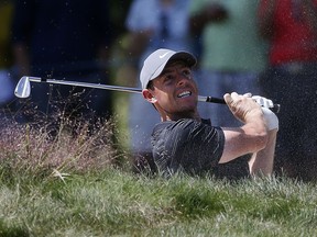 Rory McIlroy hits out of a bunker on the fifth hole during the third round of the Dell Technologies Championship golf tournament at TPC Boston in Norton, Mass., Sunday, Sept. 2, 2018.