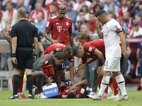 Bayern's Corentin Tolisso lies injured on the ground during the German Bundesliga soccer match between FC Bayern Munich and Bayer Leverkusen in Munich, Germany, Saturday, Sept. 15, 2018.