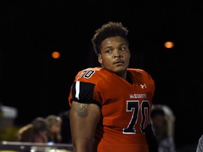 FILE - In this Sept. 16, 2016, file photo, McDonogh high school football lineman Jordan McNair watches from the sideline during a game in McDonogh, Md. An independent investigation into the death of University of Maryland football player Jordan McNair has determined that trainers on the scene did not follow proper procedures after he collapsed on the field. McNair was hospitalized on May 29 after a team workout and died June 13. The family attorney said the cause of death was heatstroke.