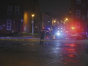Baltimore City police officers block off the scene of a shooting in Baltimore on Sunday, Sept. 23, 2018. The shootout between a man in a violence-prone Baltimore district and a police officer taking part in a crime suppression initiative has left the officer wounded and the suspect dead Sunday evening, Baltimore's interim police chief said.