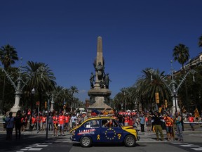 A man drives a car reading in Catalan: "Freedom for the political prisoners" during Catalan National Day in Barcelona, Spain, Tuesday, Sept. 11, 2018. Catalan separatist authorities have made a call to flood the streets of Barcelona later on Tuesday in a march calling for independence from Spain. The traditional march on the Sept. 11 "Diada," which remembers the fall of the Catalan capital to Spanish forces in 1714, is expected to attract this year hundreds of thousands of secession sympathisers.