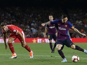 FC Barcelona's Lionel Messi, right, in action during the Spanish La Liga soccer match between FC Barcelona and Girona at the Camp Nou stadium in Barcelona, Spain, Sunday, Sept. 23, 2018.