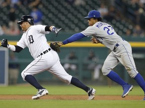 Detroit Tigers' Victor Martinez, left, is caught in a rundown by Kansas City Royals second baseman Adalberto Mondesi during the first inning of a baseball game Thursday, Sept. 20, 2018, in Detroit.