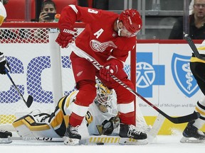 Pittsburgh Penguins goalie Tristan Jarry (35) stops a shot against Detroit Red Wings left wing Justin Abdelkader (8) during the third period of an NHL preseason hockey game, Wednesday, Sept. 19, 2018, in Detroit. The Red Wings defeated the Penguins 3-2.