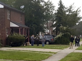 Police gather at a Detroit home where a man was shot and killed early Friday, Sept. 14, 2018, by police during the execution of a search warrant in connection with the death of a 5-year-old girl.