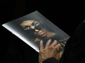 A person holds a program during the funeral service for Aretha Franklin at Greater Grace Temple, Friday, Aug. 31, 2018, in Detroit. Franklin died Aug. 16, 2018 of pancreatic cancer at the age of 76.