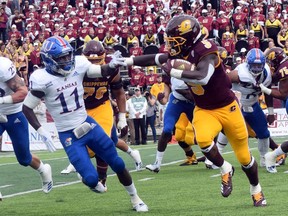 Central Michigan running back Jonathan Ward (5) carries the ball as Kansas safety Mile Lee (11) closes in during an NCAA college football game Saturday, Sept. 8, 2018, in Mount Pleasant, Mich.