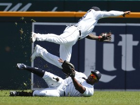 Detroit Tigers left fielder Christin Stewart, bottom, makes the catch on a Houston Astros' Evan Gattis fly ball as shortstop Niko Goodrum (28) collides with him in the second inning of a baseball game in Detroit, Wednesday, Sept. 12, 2018.