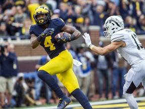 Michigan wide receiver Nico Collins (4) makes a 44-yard touchdown reception as Western Michigan defensive back Harrison Taylor (13) closes in during the second quarter of an NCAA college football game in Ann Arbor, Mich., Saturday, Sept. 8, 2018.