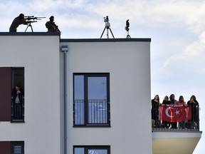 Special police officers stand on a roof waiting for Turkish President Recep Tayyip Erdogan opening the new mosque in Cologne, Germany, on Saturday, Sept. 29, 2018.