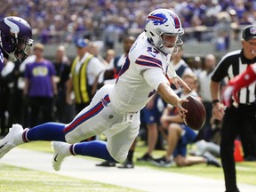 Buffalo Bills quarterback Josh Allen dives to the end zone during a 10-yard touchdown run during the first half of an NFL football game against the Minnesota Vikings, Sunday, Sept. 23, 2018, in Minneapolis.