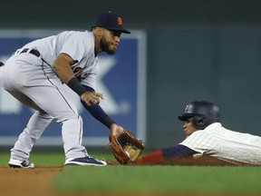 Minnesota Twins' Jorge Polanco, right, beats the tag by Detroit Tigers second baseman Dawel Lugo to steal second base during the first inning of a baseball game Wednesday, Sept. 26, 2018, in Minneapolis.