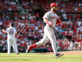Cincinnati Reds' Eugenio Suarez, right, rounds the bases after hitting a two-run home run off St. Louis Cardinals relief pitcher Bud Norris (26) during the tenth inning of a baseball game Sunday, Sept. 2, 2018, in St. Louis.