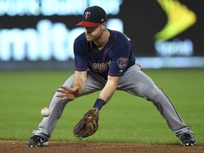 Minnesota Twins second baseman Logan Forsythe makes a play on a ground ball to throw out Kansas City Royal Rosell Herrera at first base during the fifth inning of a baseball game in Kansas City, Mo., Saturday, Sept. 15, 2018.
