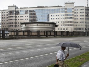 FILE - In this Saturday, July 14, 2018 file photo, a man walks past the building of the Main Directorate of the General Staff of the Armed Forces of Russia, also know as Russian military intelligence service in Moscow, Russia. The Russian military intelligence service GRU with a brutish reputation is increasingly taking on high-profile, high-risk operations to damage Russia's enemies, or simply strike fear.