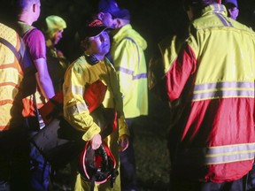 In this Friday, Sept. 7, 2018 photo, crews search for a Greene County Sheriff's deputy believed to have been swept away by high water in northern Greene County in Mo. The Springfield News-Leader reports that 35-year-old Greene County Deputy Aaron Paul Roberts had just returned to service following a 911 hang-up call Friday night when he radioed that his car had been washed off the road into the Pomme de Terre River in Fair Grove, Mo. Sheriff Jim Arnott says Roberts' body was found inside the car a short time later.