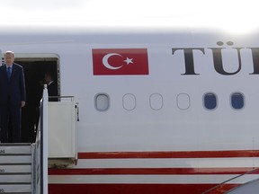 Turkey's President Recep Tayyip Erdogan, right, and his wife Emine, left, arrive at the airport Tegel for an official state visit in Germany at the capital Berlin, Thursday, Sept. 27, 2018.