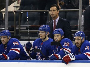 New York Rangers head coach David Quinn looks on with his players in the first period of a preseason NHL hockey game against the New Jersey Devils Monday, Sept. 24, 2018, in New York.