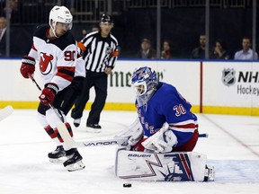 New York Rangers goaltender Henrik Lundqvist makes a save in front of New Jersey Devils' Marcus Johansson (90) in the first period of a preseason NHL hockey game, on Monday, Sept. 24, 2018, in New York.