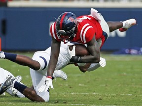 Mississippi wide receiver A.J. Brown (1) is upended by a Kent State defender after catching a pass during the first half of the NCAA college football game in Oxford, Miss., Saturday, Sept. 22, 2018.