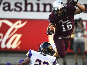 Montana wide receiver Jerry Louie-McGee (16) hurdles Northern Iowa defensive back A.J. Allen (23) during an NCAA college football game Saturday, Sept. 1, 2018, in Missoula, Mont.