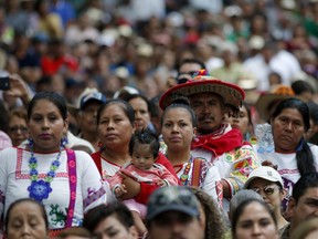 Supporters of Mexican President-elect Andres Manuel Lopez Obrador listen to him speak in Tepic, Mexico, Sunday, Sept. 16, 2018. Lopez Obrador is beginning a nationwide tour ahead of his Dec. 1 inauguration.