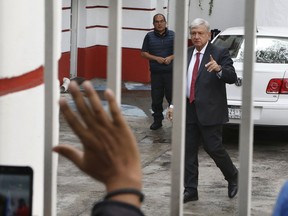 Mexico's President-elect Andres Manuel Lopez Obrador greets supporters as he arrives to his party's headquarters in Mexico City, Thursday, Sept. 13, 2018. Lopez Obrador takes office Dec. 1.