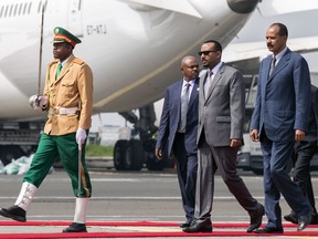 FILE - In this Saturday, July 14, 2018 file photo, Eritrea's President Isaias Afwerki, right, is welcomed by Ethiopia's Prime Minister Abiy Ahmed, 2nd right, for his first visit in 22 years, at the airport in Addis Ababa, Ethiopia. Celebrating their dramatic diplomatic thaw, the leaders of Ethiopia and Eritrea on Tuesday, Sept. 11, 2018 marked the Ethiopian new year at a border where a bloody war and ensuing tensions had divided them for decades.