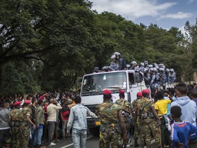 Members of the army and riot police attempt to control protestors from the capital and those displaced by ethnic-based violence over the weekend in Burayu, as they demonstrate to demand justice from the government in Addis Ababa, Ethiopia Monday, Sept. 17, 2018. Several thousand Ethiopians have gone out onto the streets of the capital to protest ethnic-based attacks in the outskirts of the city in which more than 20 people died over the weekend.