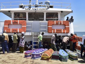Coffins for the victims of the MV Nyerere passenger ferry are transported by another ferry to Ukara Island, Tanzania Saturday, Sept. 22, 2018. The death toll soared past 200 on Saturday while officials said a survivor was found inside the capsized ferry and search efforts were ending to focus on identifying bodies, two days after the Lake Victoria disaster. (AP Photo)