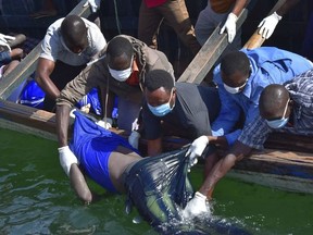Rescuers retrieve a  body from the water near Ukara Island in Lake Victoria, Tanzania Friday, Sept. 21, 2018. The death toll rose above 100 after the passenger ferry MV Nyerere capsized on Lake Victoria, Tanzania state radio reported Friday, while a second day of rescue efforts raced the setting sun. (AP Photo)