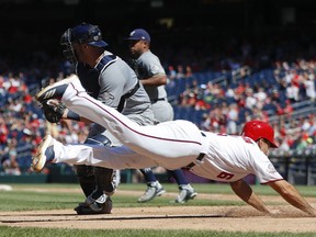 Washington Nationals Anthony Rendon slides and scores past Milwaukee Brewers catcher Manny Pina on a hit by teammate Mark Reynolds during the third inning of a baseball game at Nationals Park, Sunday, Sept. 2, 2018, in Washington.