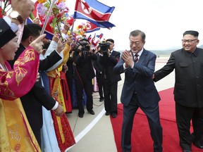 South Korean President Moon Jae-in, second from right, is greeted by North Koreans as North Korean leader Kim Jong Un, right, watches during a welcome ceremony at Sunan International Airport in Pyongyang, North Korea, Tuesday, Sept. 18, 2018. The leaders announced a wide range of agreements which they said were a major step toward peace on the Korean Peninsula. (Pyongyang Press Corps Pool via AP)