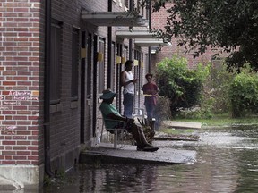 Residents at Trent Court Apartments wait out the weather as rising waters get closer to their doors in New Bern, N.C. Thursday, Sept. 13, 2018. Hurricane Florence already has inundated coastal streets with ocean water and left tens of thousands without power, and more is to come.