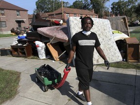 Volunteer Johnnie Evans brings a wagon of water to cleanup crews helping with the grisly task of removing storm damaged belongings, spoiled food and soaked furniture at Trent Court Apartments in New Bern, N.C., Sept. 21, 2018. Hurricane Florence brought storm surges which overflowed from the Trent River and forced many residents of Trent Court to evacuate.