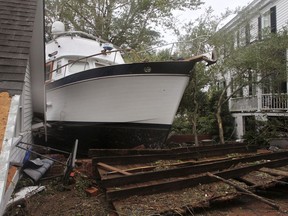 A 40-foot yacht lies in the yard of a storm-damaged home on East Front Street in New Bern, N.C., Saturday, Sept. 15, 2018. The boat washed up with storm surge and debris from Hurricane Florence.