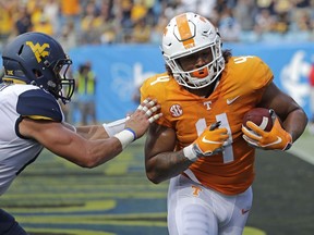 Tennessee's Dominick Wood-Anderson (4) catches a touchdown pass in front of West Virginia's Dylan Tonkery (10) in the first half of an NCAA college football game in Charlotte, N.C., Saturday, Sept. 1, 2018.