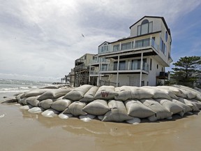 Sand bags surround homes on North Topsail Beach, N.C., Wednesday, Sept. 12, 2018, as Hurricane Florence threatens the coast.
