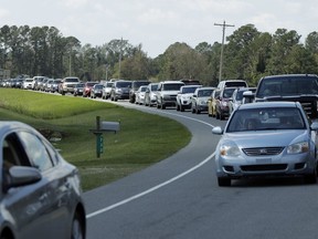 People sit in a long line of bumper to bumper traffic on US 421 in Harrells, N.C., Wednesday, Sept. 19, 2018 as they try to make their way toward Wilmington, N.C.